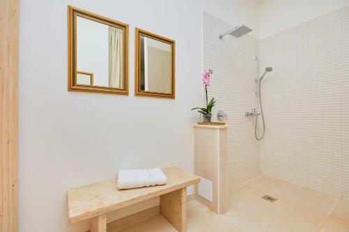 a bathroom with a shower and a bench with a sink at Villa San Mauro in Momjan