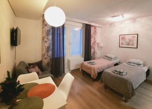 a living room with two beds and a couch at Patria apartments in Lahti
