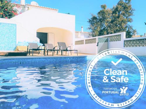 a swimming pool with a sign that reads clean and safe at Villa Luz Bay w Private Pool in Luz