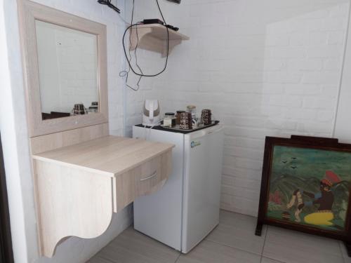 a kitchen with a white refrigerator and a mirror at Myrtles Retreat in Stilbaai