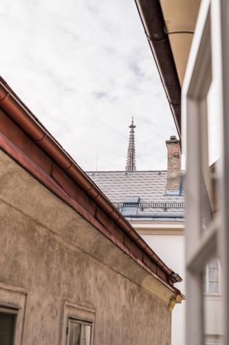 a view of the roof of a building with a tower in the background at Stephansdom Premium Apartments in Vienna