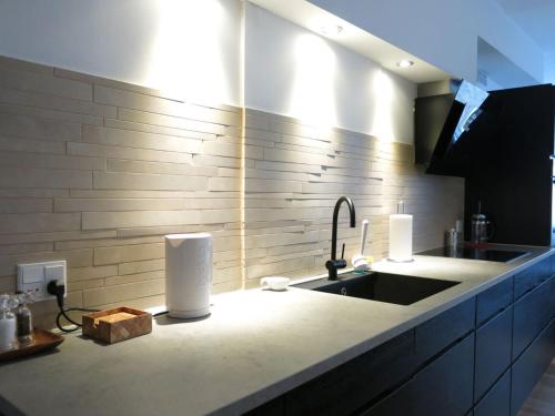 a kitchen with a sink and a counter top with a sink at ApartmentInCopenhagen Apartment 936 in Copenhagen