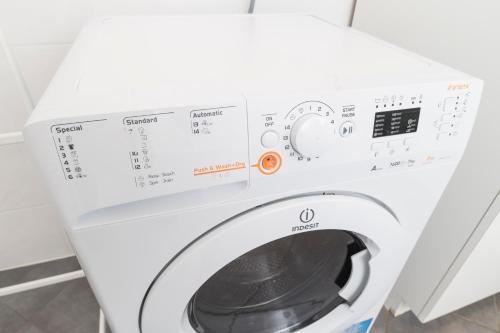 a white washing machine with its door open at Stephansdom Premium Apartments in Vienna