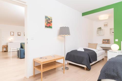 a small bedroom with a bed and a table at Stephansdom Premium Apartments in Vienna