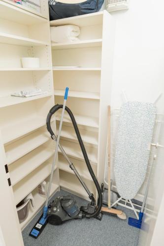 a room with a vacuum cleaner and a chair at Stephansdom Premium Apartments in Vienna