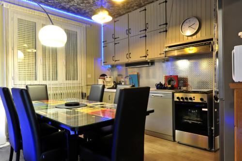 une cuisine avec une table et des chaises dans une pièce dans l'établissement JAZZAPPART appartement classé 3 étoiles, à Gentilly