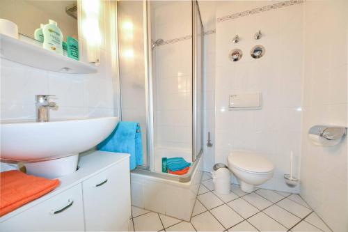 a bathroom with a shower and a sink and a toilet at Haus Miramar 31 in Ahlbeck