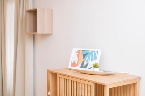 a wooden table with a laptop on top of it at Stephansdom Premium Apartments in Vienna