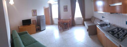 a kitchen with a couch and a table in a room at Residence Al Granzo in Trieste