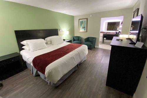 a hotel room with a large bed and a desk at Lx Hotel, Manchester, Tennessee in Manchester