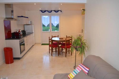 a kitchen and dining room with a table and chairs at Morgane du Val in Campénéac