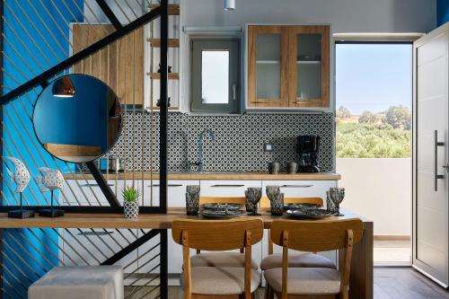 a kitchen with a table with chairs and a mirror at Theasea Stylish Residences in Panormos Rethymno