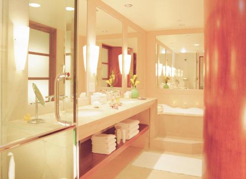 a bathroom with a shower and a sink and a tub at Taj Campton Place in San Francisco