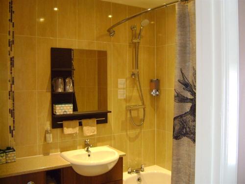 a bathroom with a sink and a shower at The Commercial Hotel in Tarland