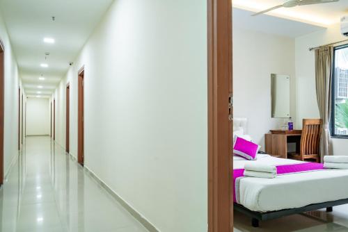 a bedroom with a bed and a mirror at Nexstay Treats Inn in Kozhikode