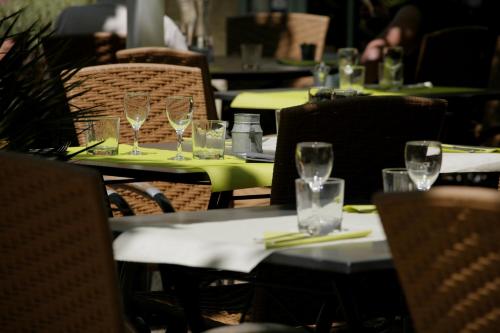 a group of tables with wine glasses on them at Logis Hotel la Ferme in Avignon