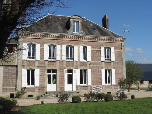 an old brick house with white doors and windows at Chambres d'Hôtes de la Bucaille in La Bucaille