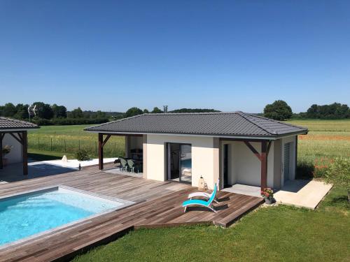 a house with a deck and a swimming pool at Lesberit in Saint-Médard-de-Guizières