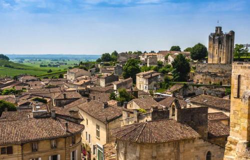 a view of a town with buildings and a tower at Lesberit in Saint-Médard-de-Guizières