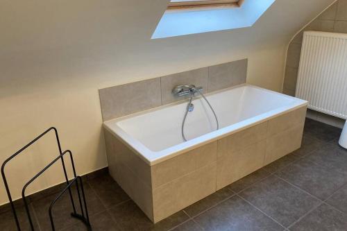 een bad met een kraan in de badkamer bij Vakantieverblijf 'Mara Cinco' met ruim terras in Oostende in Oostende