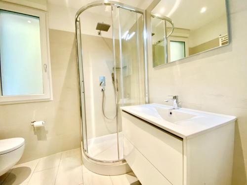 a bathroom with a shower and a sink at Tower 44 in Luino