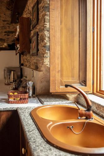a sink in a kitchen with a counter top at Lugar del Rio in Couzadoiro