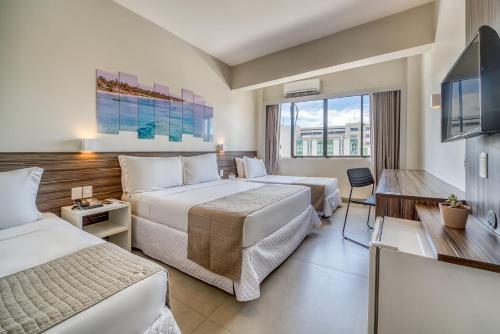 Postel nebo postele na pokoji v ubytování Tambaqui Praia Hotel