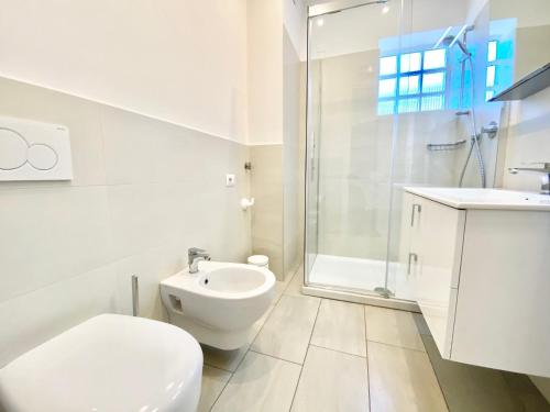 a bathroom with a toilet and a sink and a shower at Tower 44 in Luino