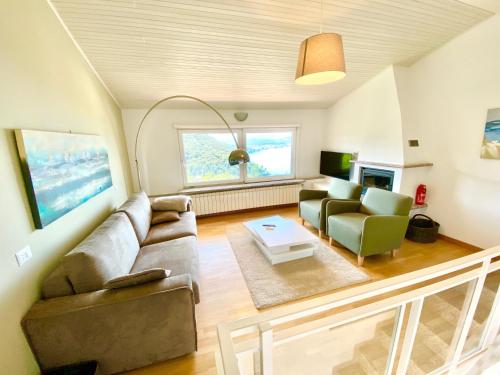 a living room with a couch and a table at Tower 44 in Luino