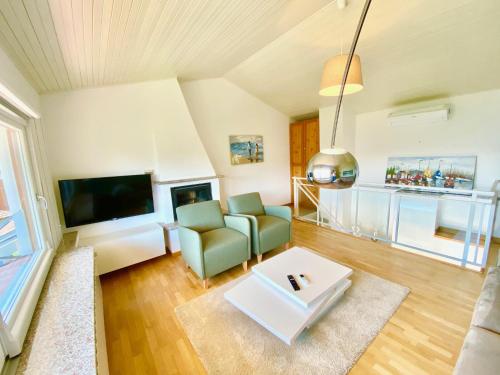 a living room with a couch and a tv at Tower 44 in Luino