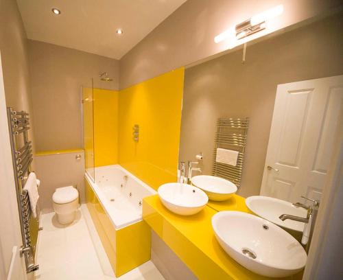 a bathroom with a sink, toilet and bathtub at The Oriental - Guest House in Brighton & Hove