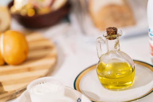 a bottle of olive oil sitting on a plate at Villa Tonia in Fasano