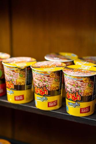 a bunch of containers of food sitting on a shelf at Mayfa Hotel - SHA extra plus in Phuket