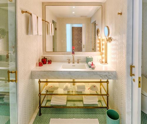 
a bathroom with a sink and a mirror at Faena Hotel Miami Beach in Miami Beach
