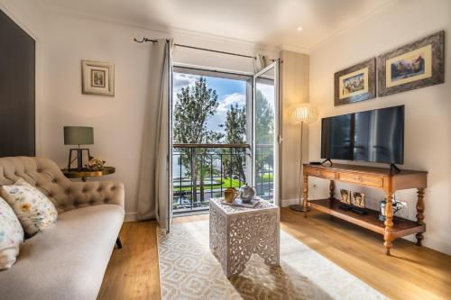 a living room with a couch and a television at Funchal Center Apartment I in Funchal