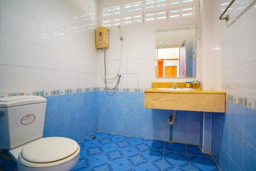 a blue and white bathroom with a toilet and a sink at Mayfa Hotel - SHA extra plus in Phuket
