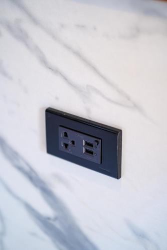 a electrical outlet on the side of a wall at Mayfa Hotel - SHA extra plus in Phuket