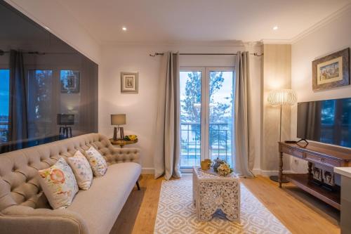 a living room with a couch and a piano at Funchal Center Apartment I in Funchal