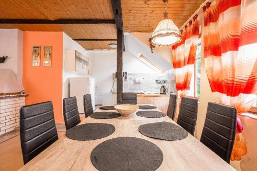 a dining room with a table and chairs at Penzion u lípy in Jestřebí