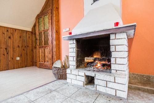 a brick fireplace in the middle of a room at Penzion u lípy in Jestřebí