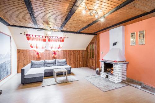 a living room with a couch and a fireplace at Penzion u lípy in Jestřebí