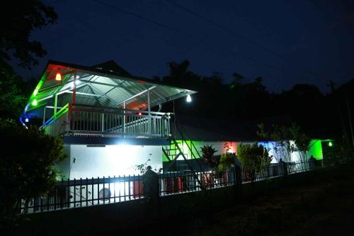 a house lit up at night with green lights at Eden Homestay Idukki in Idukki