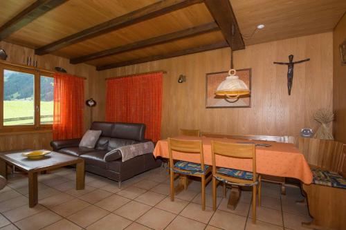 a living room with a table and a couch at Chalet Falki in Adelboden