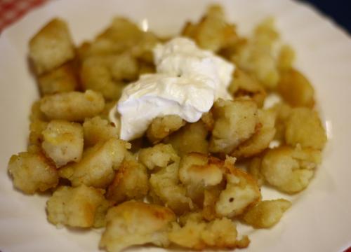 a plate of food with tater tots and whipped cream at Centrum Étterem és Panzió in Őriszentpéter