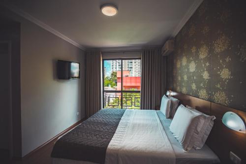 Postel nebo postele na pokoji v ubytování Hotel Rafain Centro
