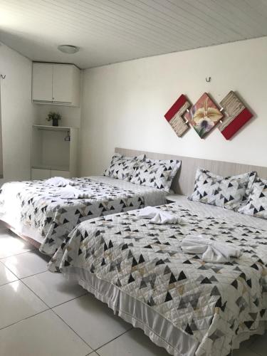 a bedroom with two beds in a room at Chalé Temporada Porto dos Lençóis - Lençóis Maranhenses in Barreirinhas