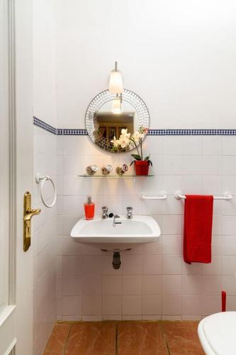 a white bathroom with a sink and a mirror at Villa Luz Bay w Private Pool in Luz
