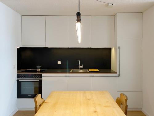 A kitchen or kitchenette at Grüezi Laax Apartments