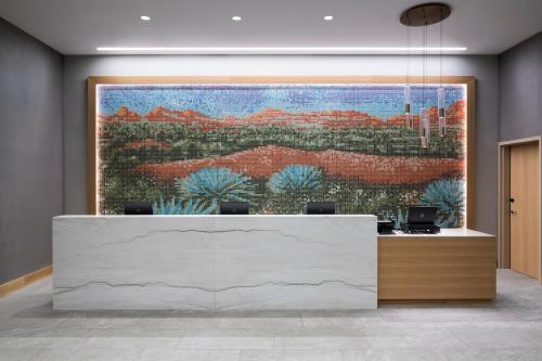 a lobby with a large painting on the wall at Hyatt Place Tempe Phoenix University in Tempe