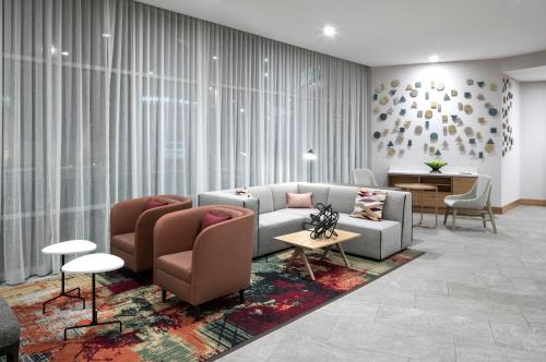 a living room with a couch and chairs and a table at Hyatt Place Tempe Phoenix University in Tempe
